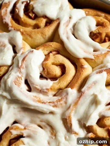 Closeup of Sourdough Discard Apple Cinnamon Rolls with frosting.