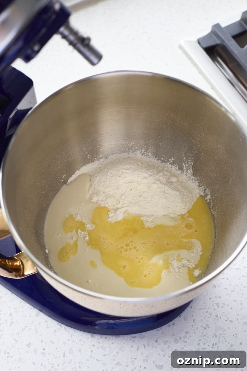 Dough ingredients in the bowl of a stand mixer.