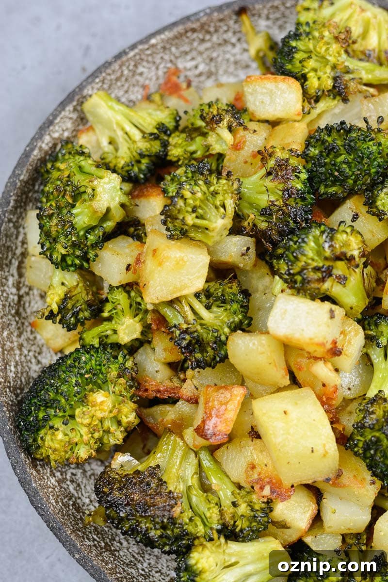 Crispy Oven-Roasted Vegetables with Garlic and Herbs 10 a bowl full of oven roasted potatoes and broccoli in a lemon dijon sauce