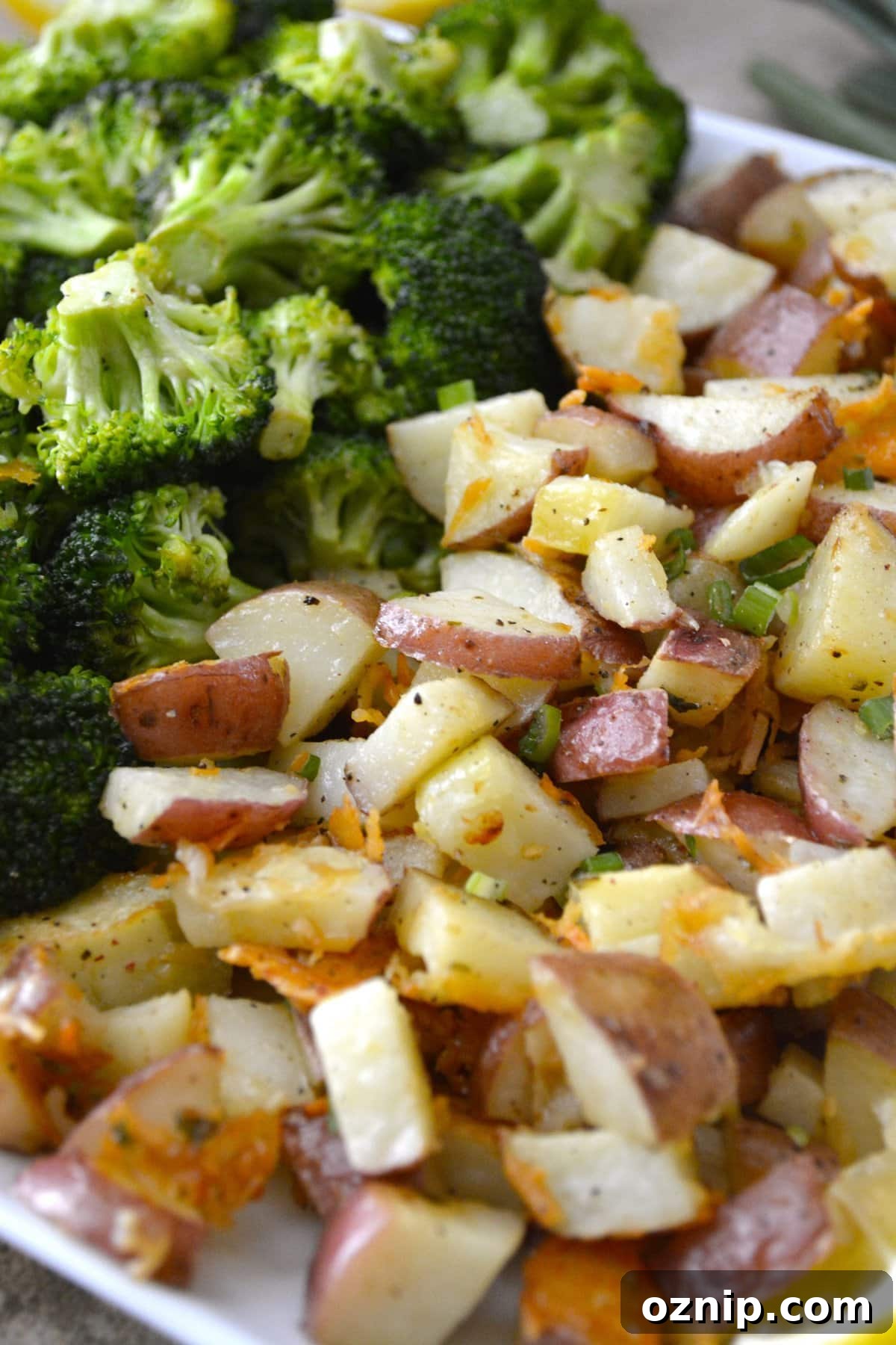 Crispy Oven-Roasted Vegetables with Garlic and Herbs 11 roasted broccoli and potatoes side by side on a baking sheet