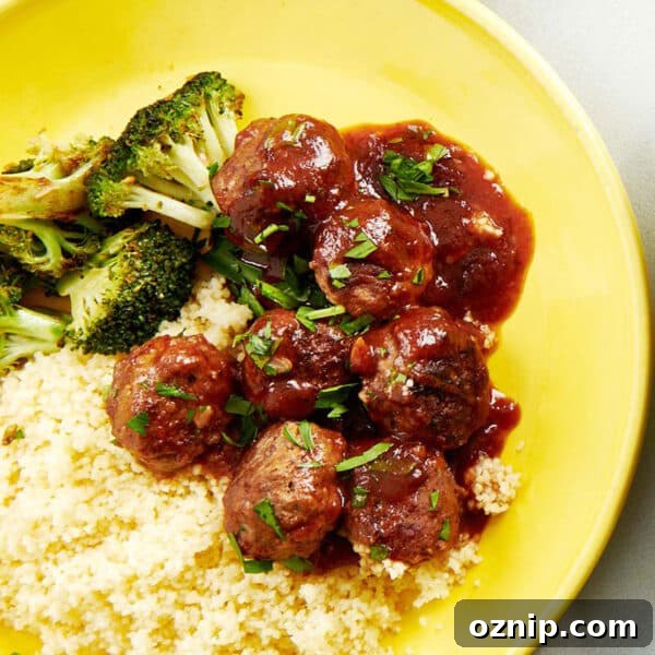 Sweet and sour meatballs over rice on yellow plate.
