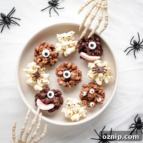 Serving bowl of chocolate Halloween popcorn balls with skeleton hands reaching in.