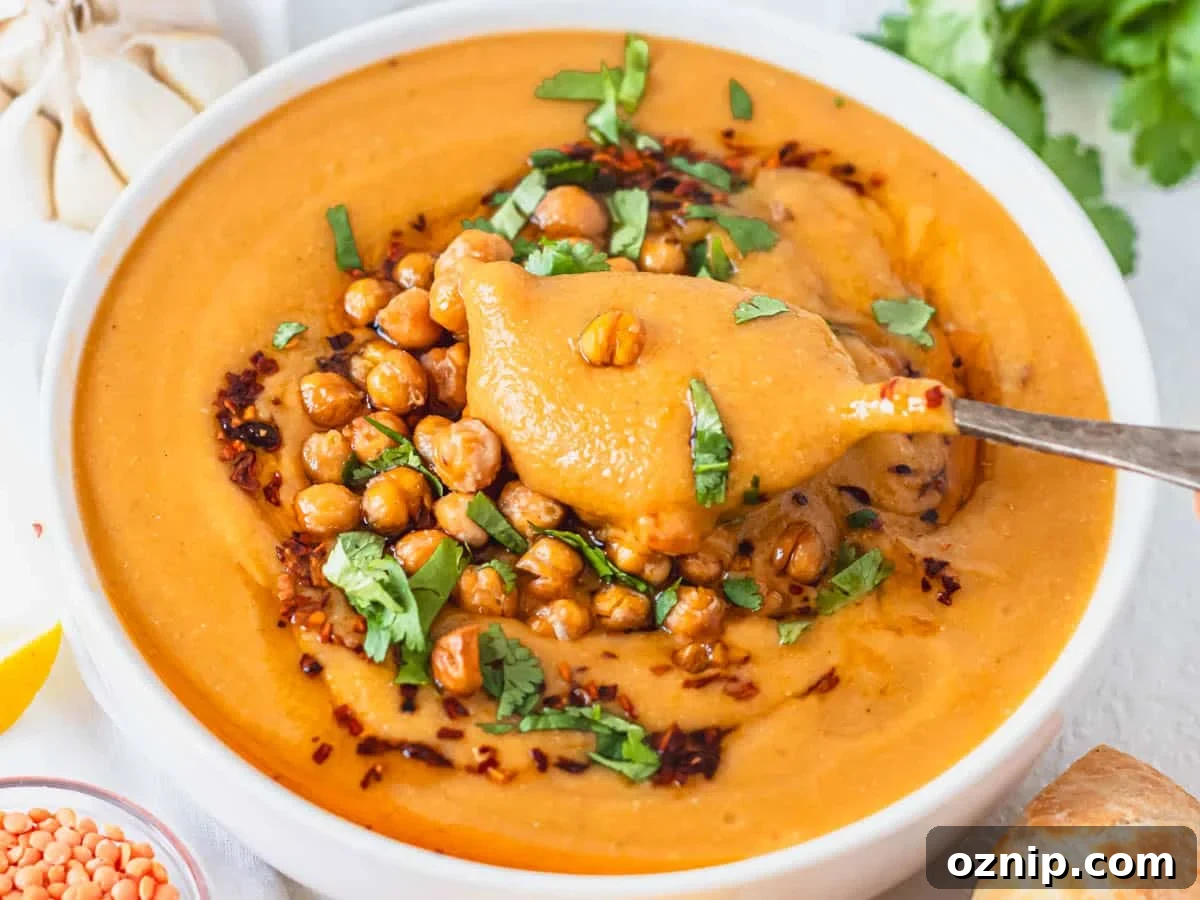 Turkish red lentil soup with roasted chickpeas and fresh cilantro on top