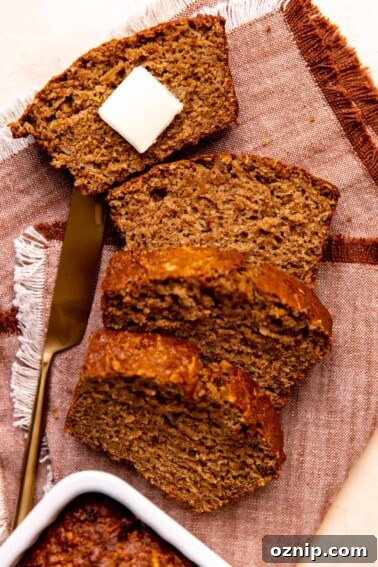 Slices of apple bread laid out with a slab of butter on top.