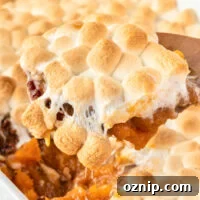 scooping sweet potato casserole from the dish