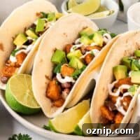 sweet potato tacos topped with sour cream and diced avocado