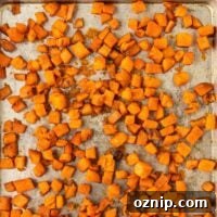 roasted sweet potato cubes on a baking sheet