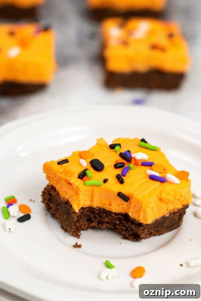 bitten cookie bar on plate with cookies bars behind it 