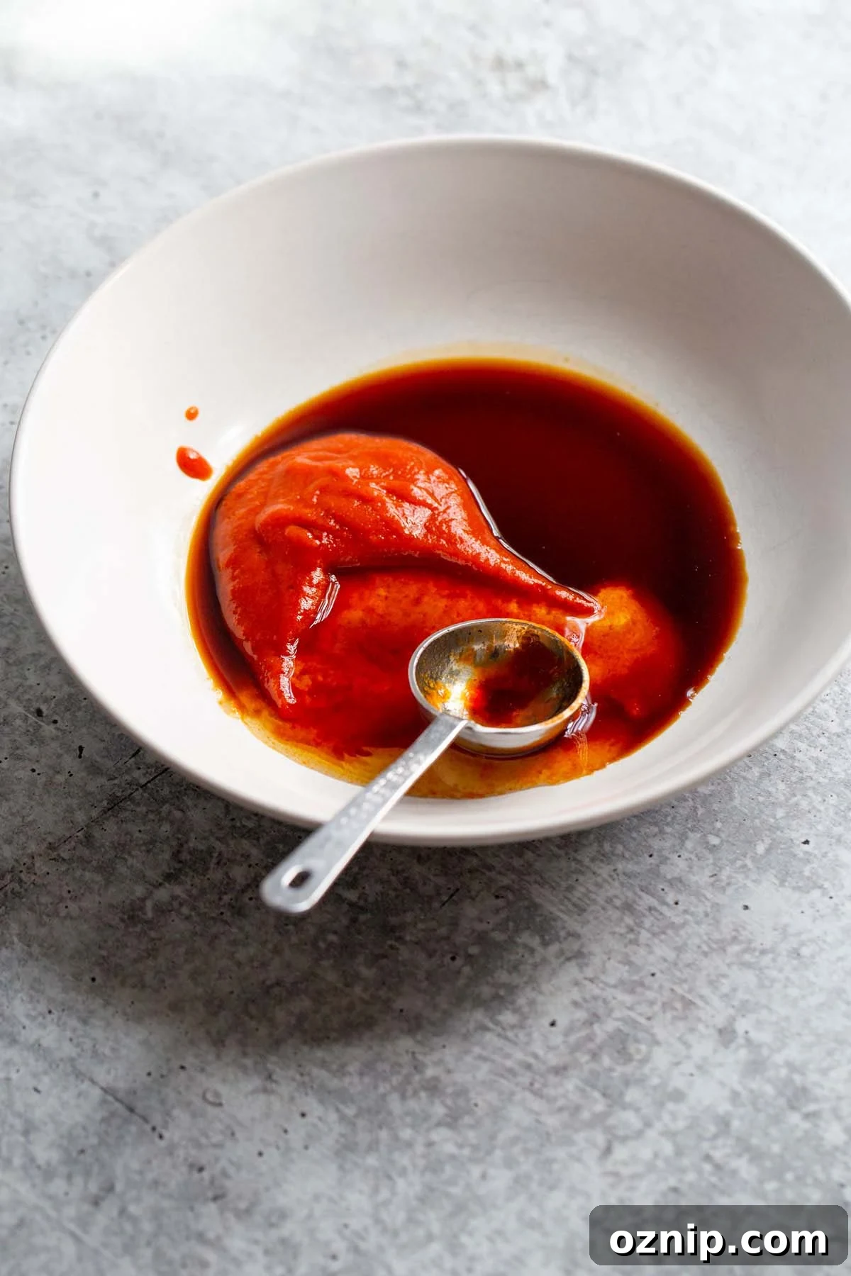 Mixing together honey sriracha sauce.