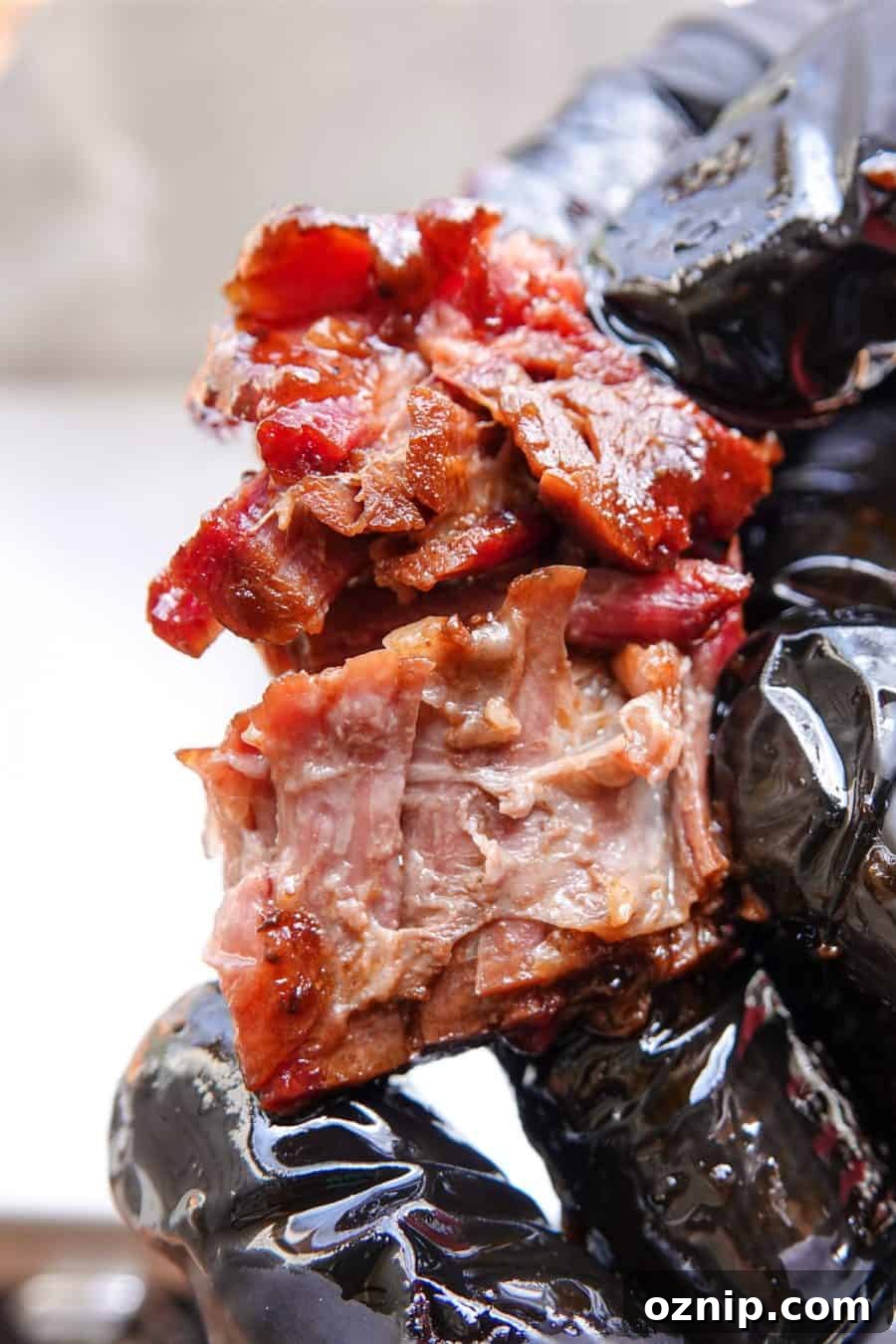 Ultra Tender Burnt Ends from Chuck Roast 2 Smoked burnt end being ripped in half with black gloves