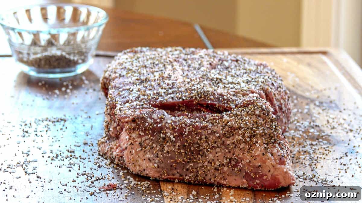 Ultra Tender Burnt Ends from Chuck Roast 3 Beef chuck roast covered in salt and pepper on cutting board with seasoning dish