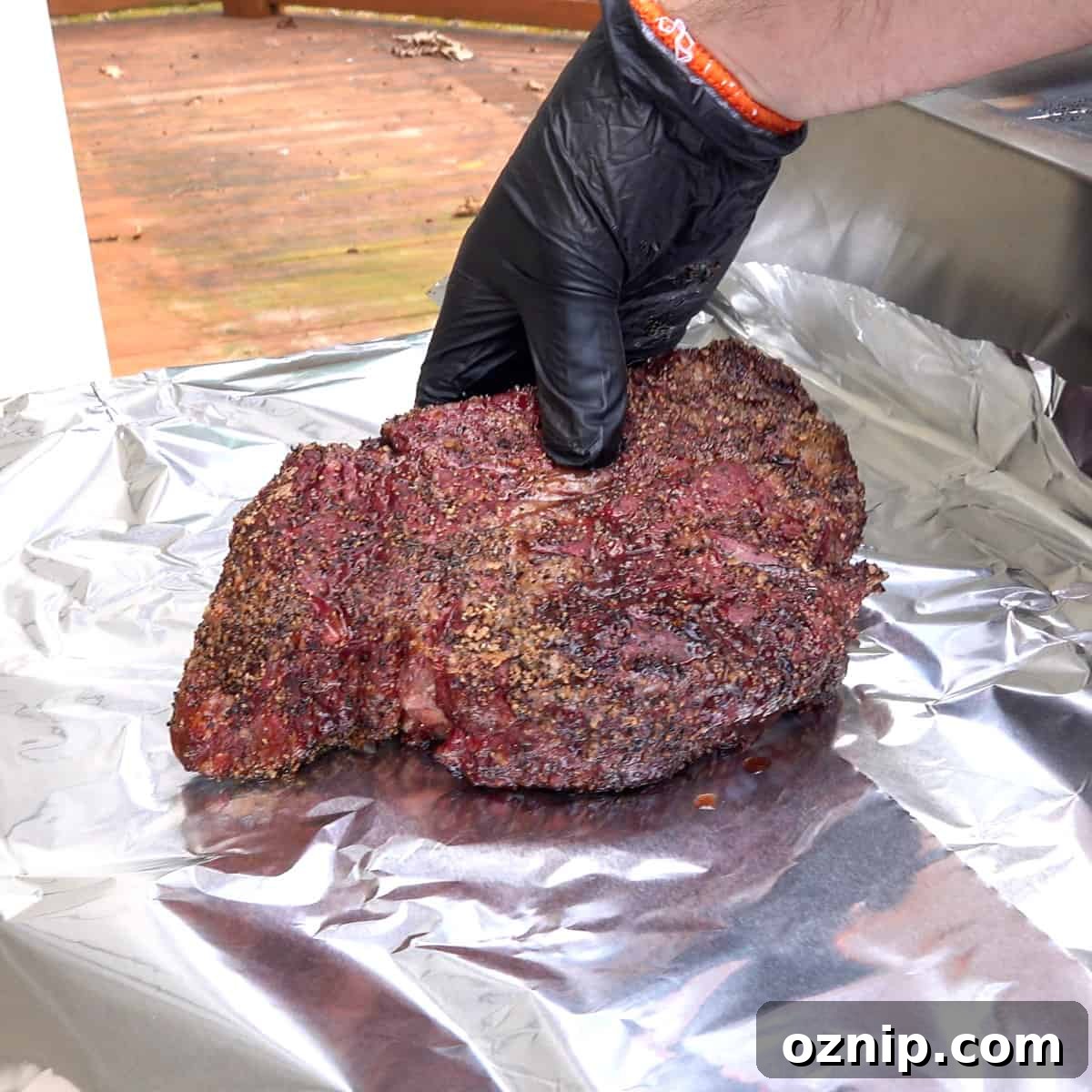 Ultra Tender Burnt Ends from Chuck Roast 4 Smoked chuck roast being placed on aluminum foil