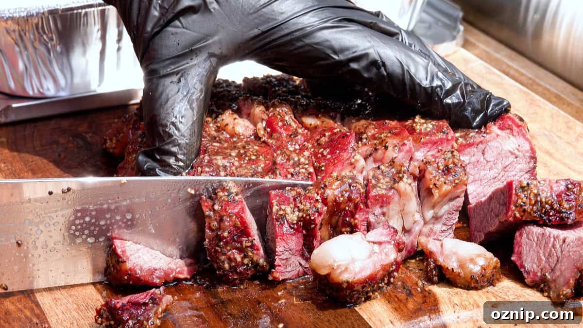 Ultra Tender Burnt Ends from Chuck Roast 7 Slicing smoked chuck roast into small pieces on cutting board for burnt ends