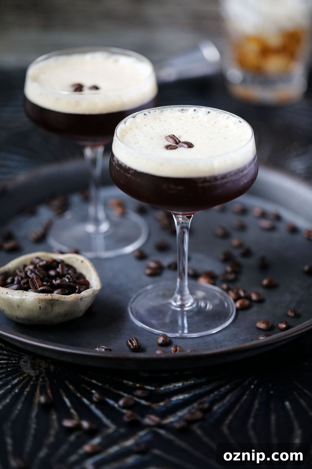 Espresso martini mocktails on a metal tray.