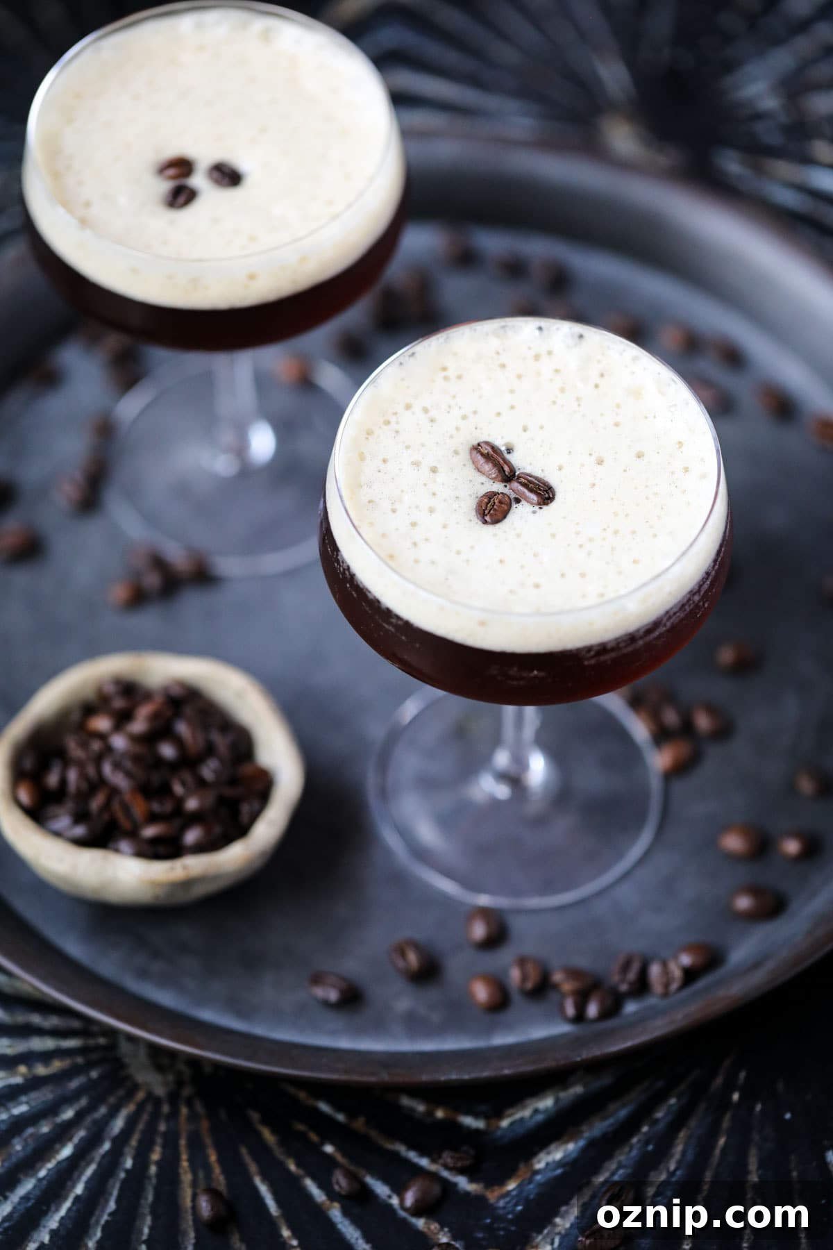 Espresso martini mocktails on a metal tray.