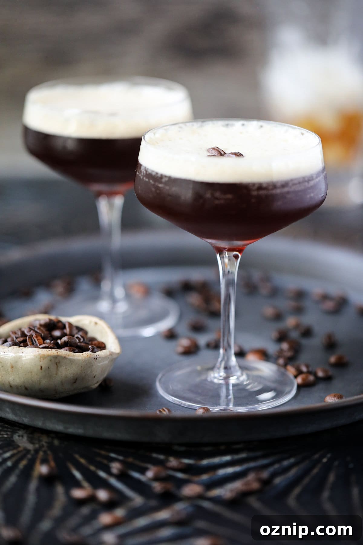 Espresso martini mocktails on a metal tray.