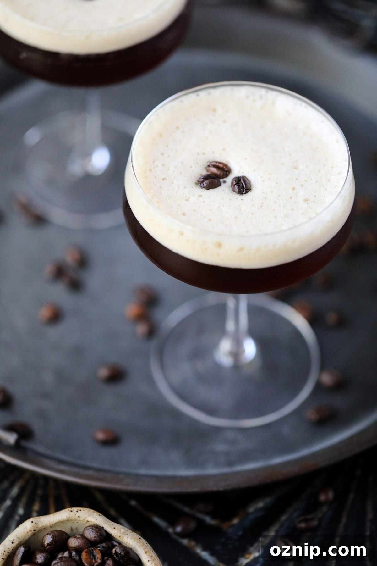 Espresso martini mocktails on a metal tray.