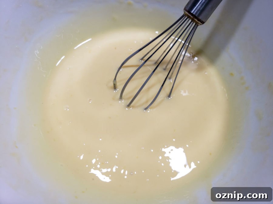 a bowl filled with a light yellow creamy key lime pie filling.