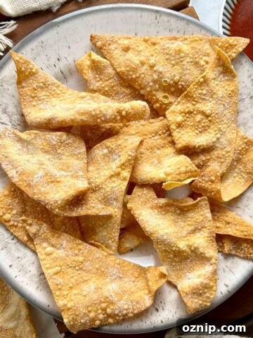 top down view of wonton chips on plate with side of sweet and sour sauce