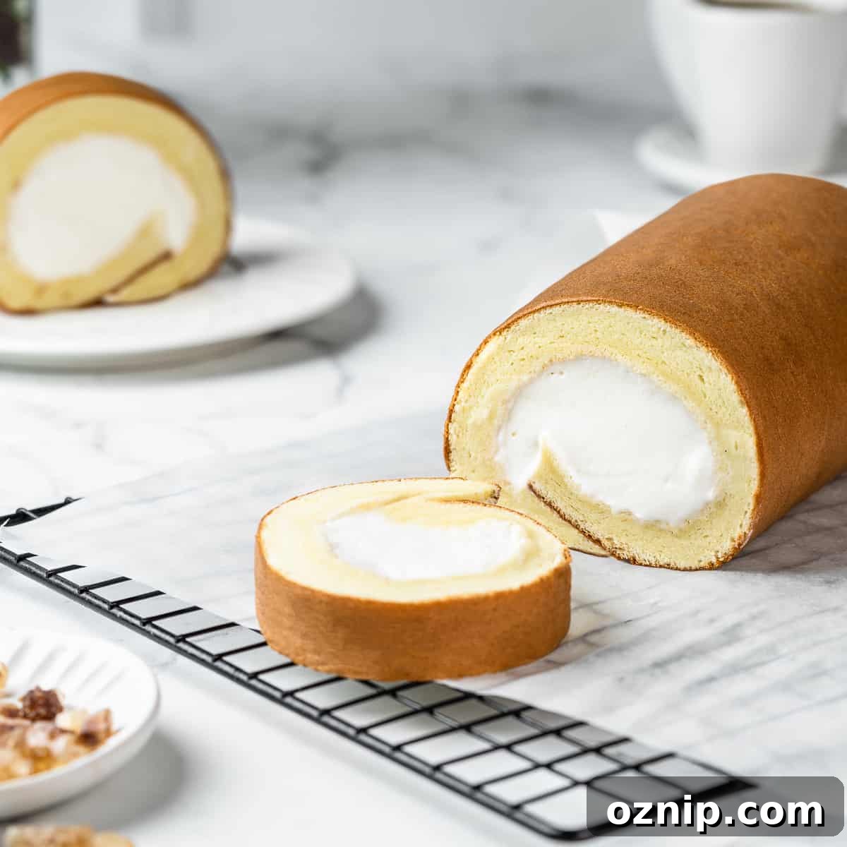 Dojima Roll: Japanese Sponge Cake Roll Recipe 2 Sliced Japanese cake roll on a wire rack lined with parchment