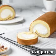 Sliced Japanese cake roll on a wire rack lined with parchment.