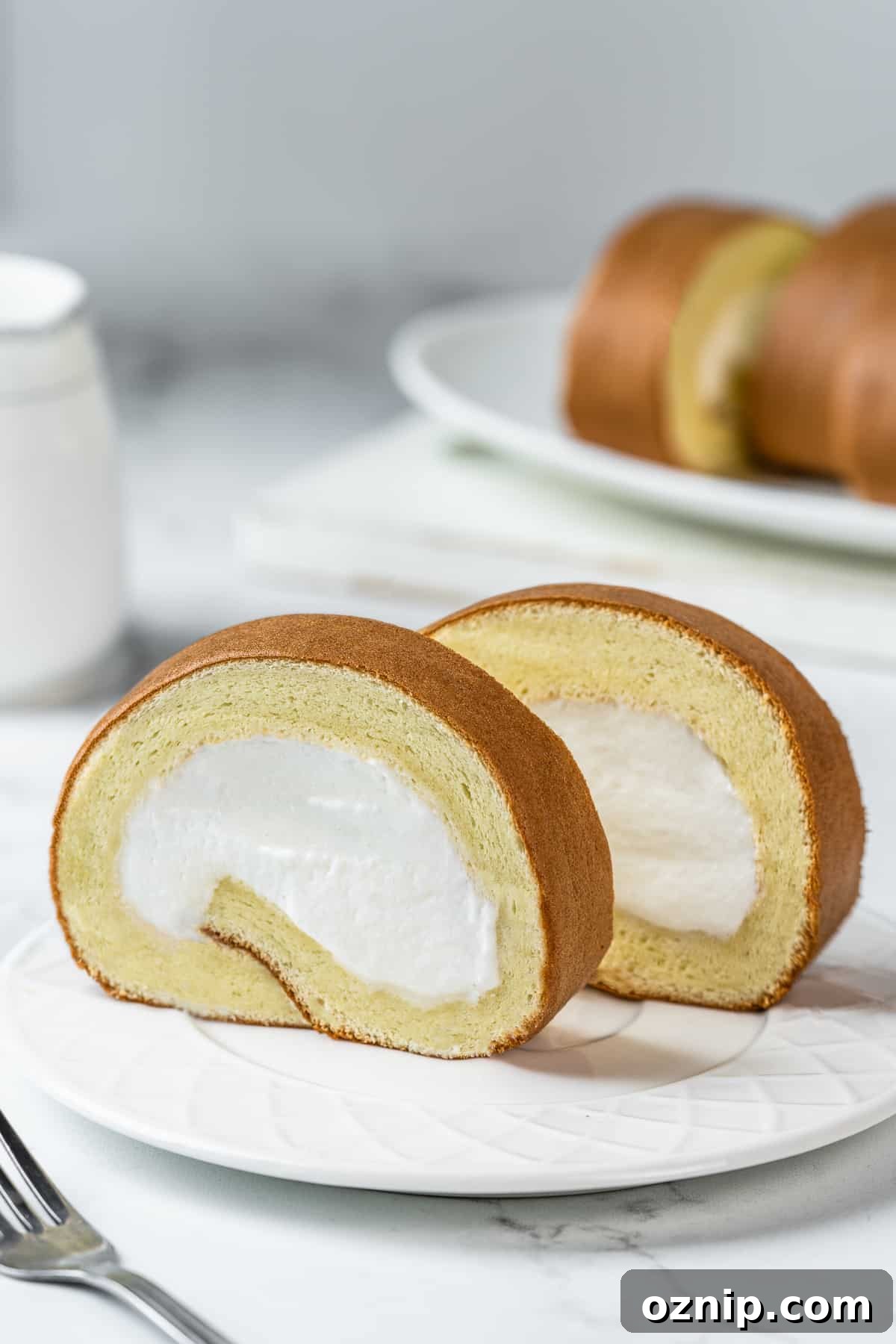 Dojima Roll: Japanese Sponge Cake Roll Recipe 3 Sliced of Japanese Dojima roll on a white dessert plate