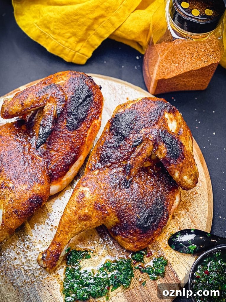 How to Grill Half Chicken for Juicy, Crispy Skin 2 grilled chicken halves on a cutting board