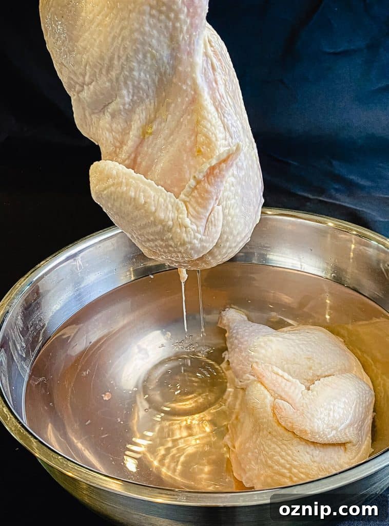 How to Grill Half Chicken for Juicy, Crispy Skin 4 half chicken being removed from brine