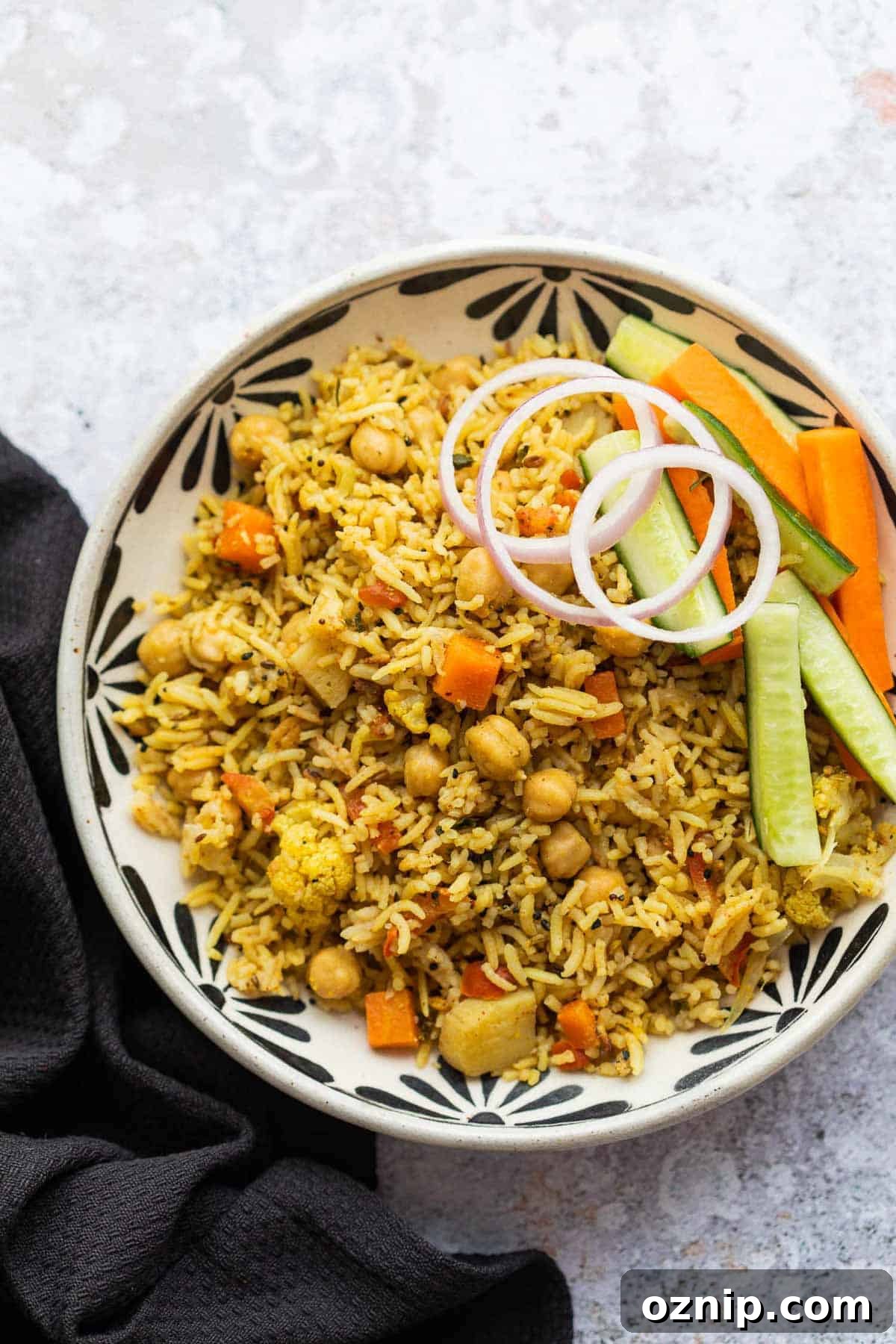 Kabuli Chana Pulao served in a bowl with onions and a salad