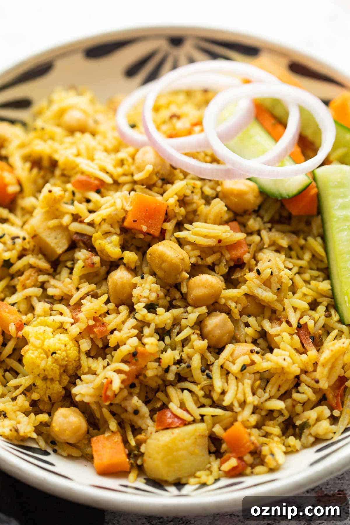 Kabuli Chana Pulao served in a bowl with onions and a salad