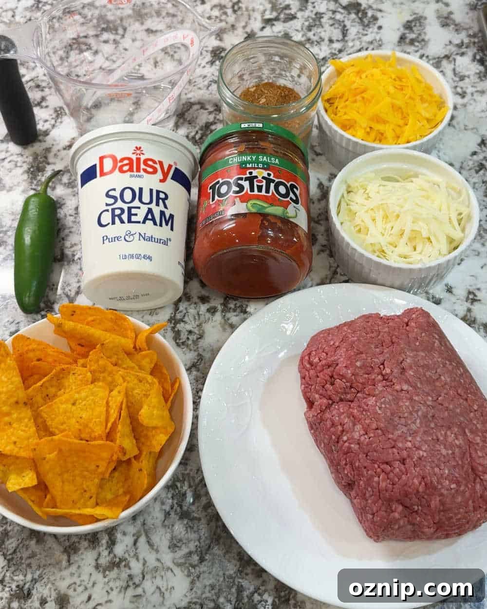 Cheesy Doritos and Ground Beef Casserole 3 ground beef, Doritos, cheese, salsa, seasoning, sour cream and jalapeno.