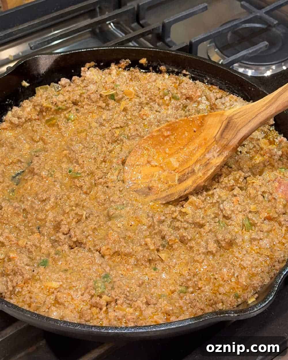 Cheesy Doritos and Ground Beef Casserole 5 stir ground beef mixture with wooden spoon.