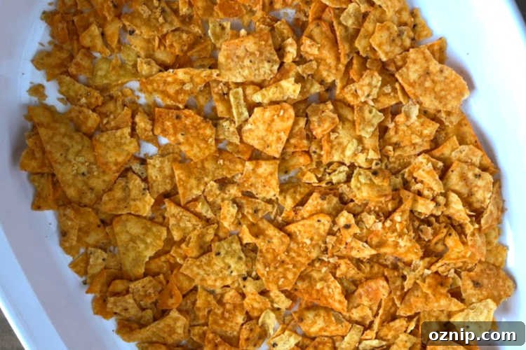 Cheesy Doritos and Ground Beef Casserole 6 crushed doritos nacho cheese chips in casserole dish