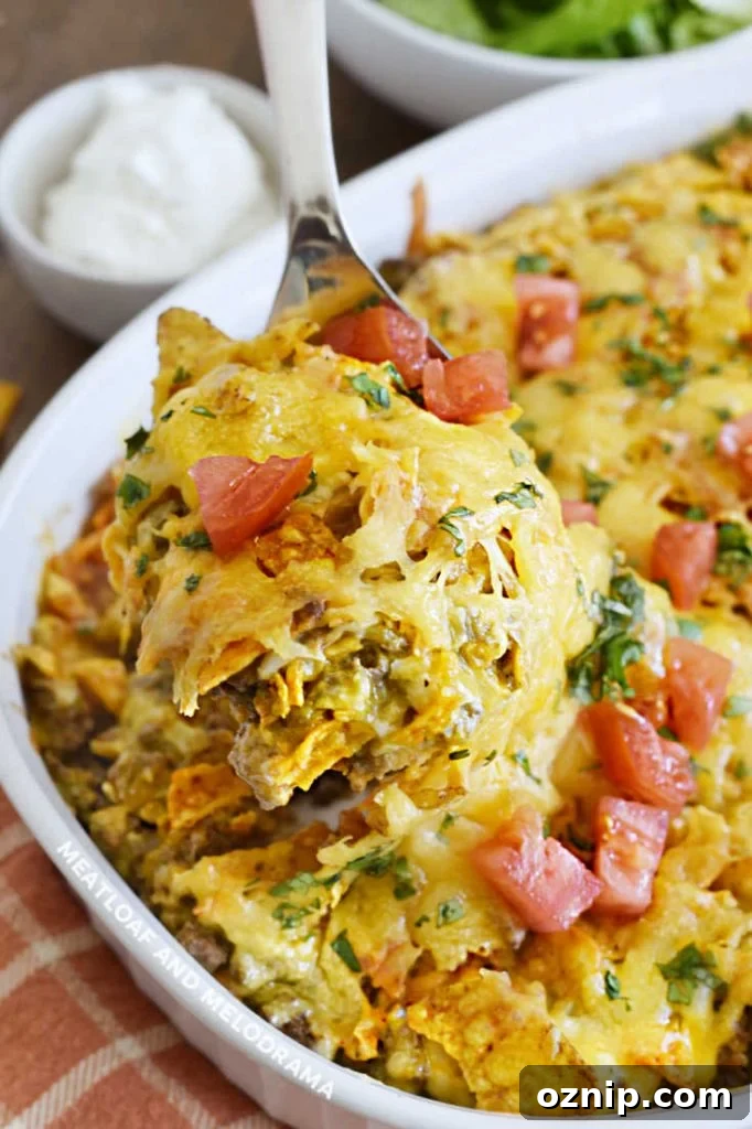 Cheesy Doritos and Ground Beef Casserole 9 doritos ground beef and cheese casserole on a serving spoon