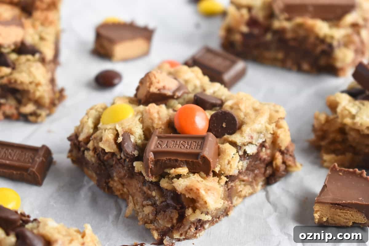 Halloween Candy Cookie Bars with Leftover Candy 2 cookie bar with candy on top and candy scattered around it.