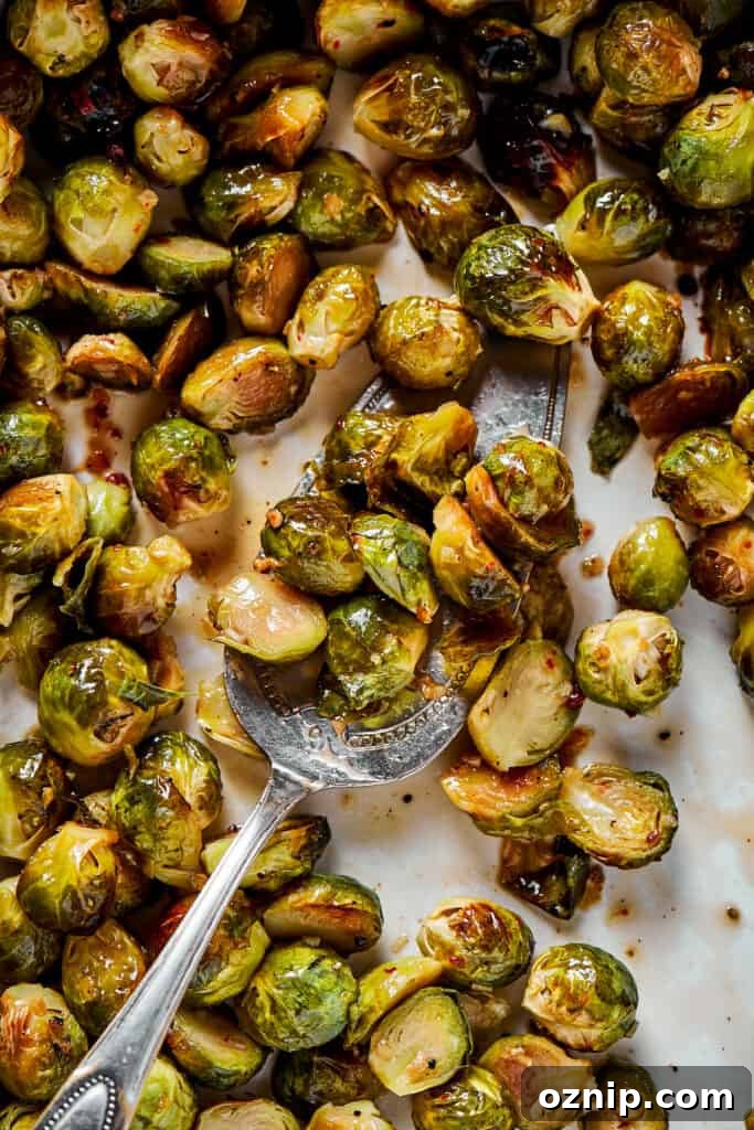Tossing roasted brussels sprouts with glaze.