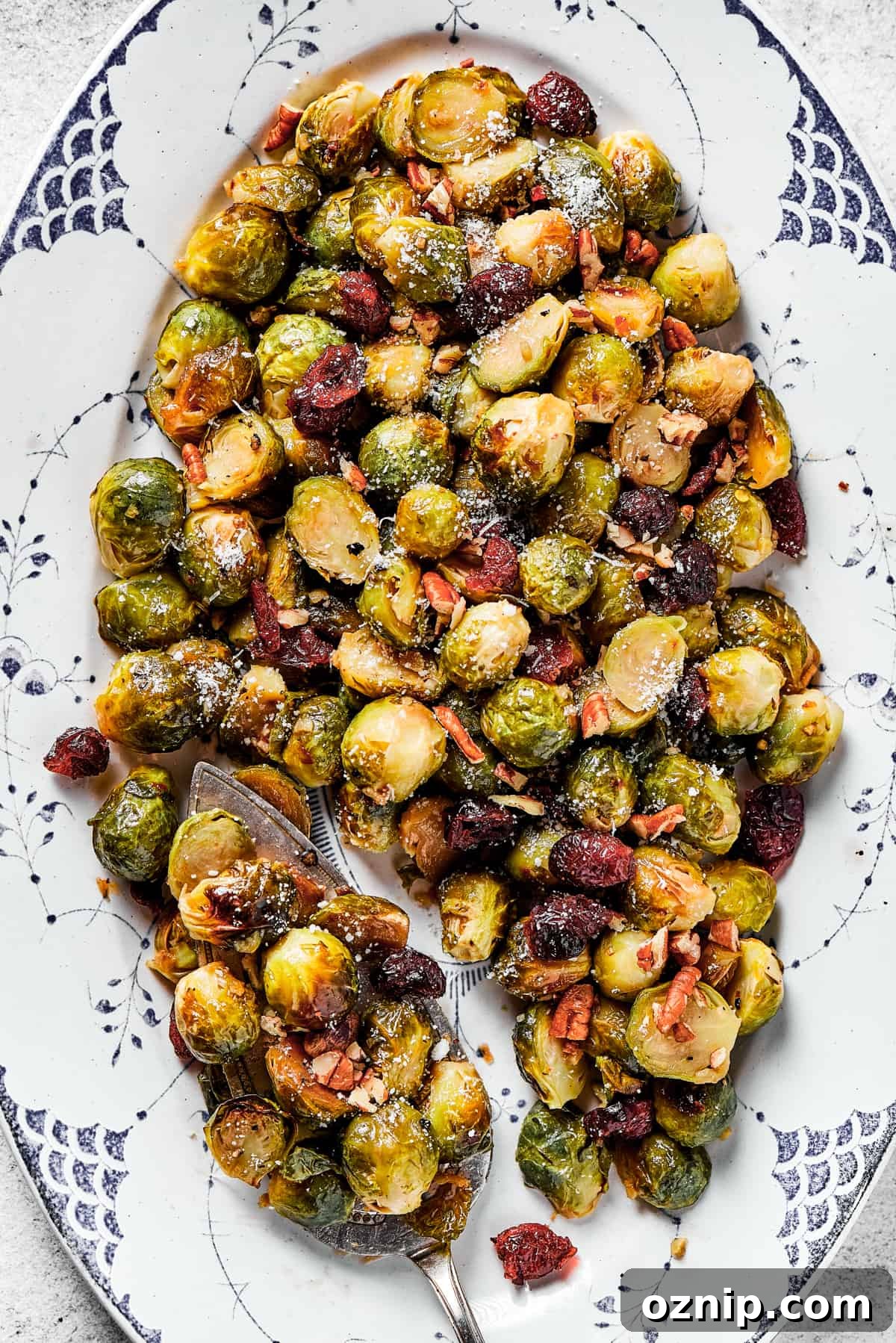 Close-up shot of glazed brussel sprouts with cranberries and pecans.