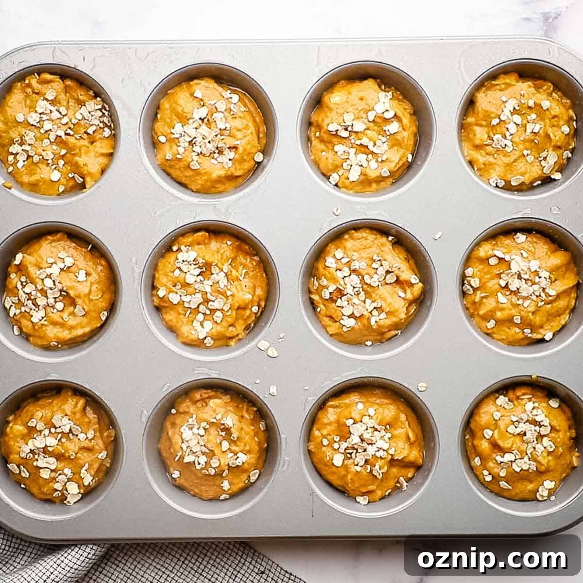 oatmeal muffin batter in a muffin tin