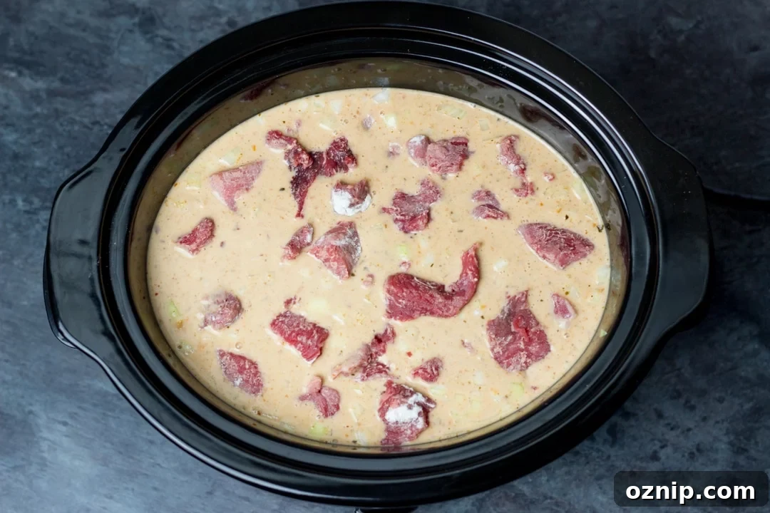 beef massaman curry sauce and beef in a slow cooker