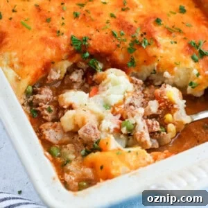 ground turkey shepherd's pie in a casserole dish with a scoop being taken out