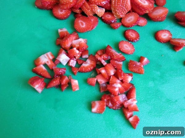 Low Sugar Apple Berry Salsa with Cinnamon Chips 4 Diced strawberries on a cutting board