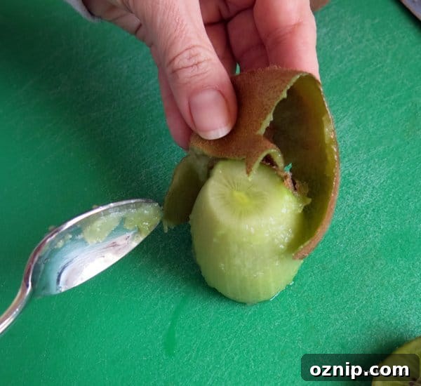 Low Sugar Apple Berry Salsa with Cinnamon Chips 6 Kiwi fruit being peels on a cutting board
