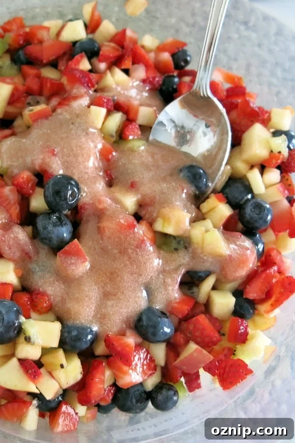 Low Sugar Apple Berry Salsa with Cinnamon Chips 7 Fruit salsa in bowl with jam and stevia glaze drizzled on top.