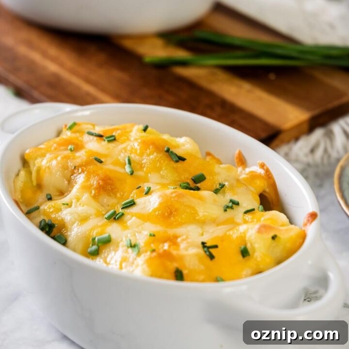 Cheesy mashed potatoes in a white casserole dish.