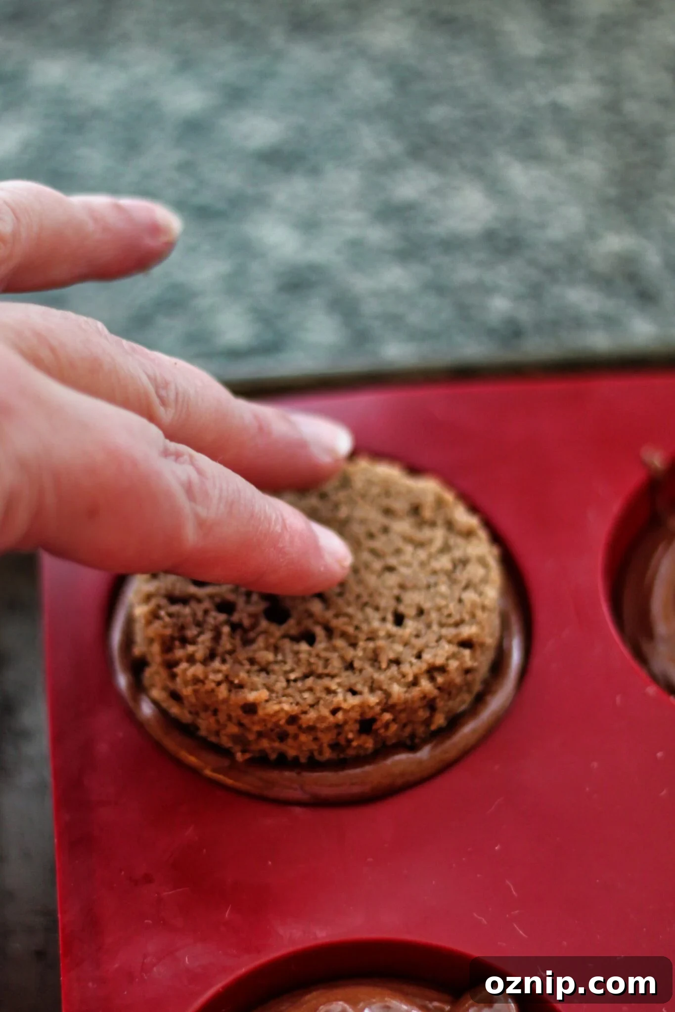 pressing rounds of cake into mousse