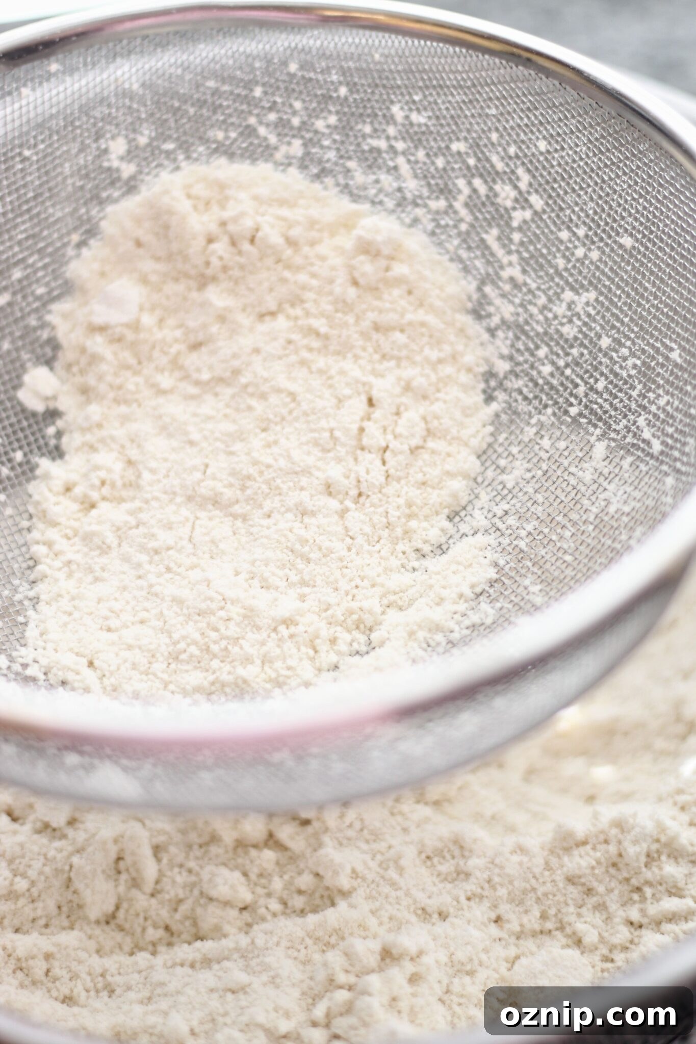 sifting powdered sugar and almond flour