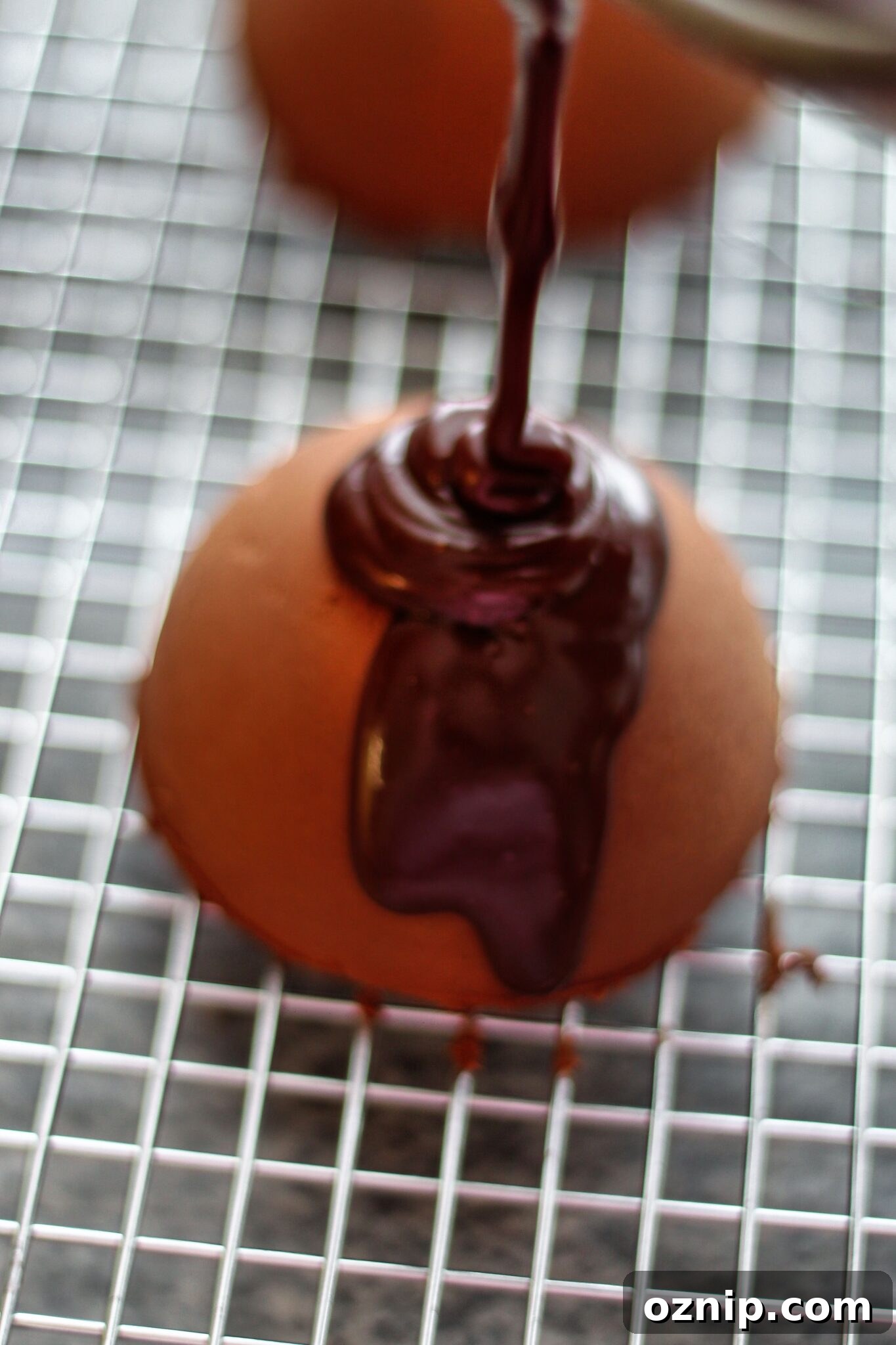 pouring ganache over mousse cakes