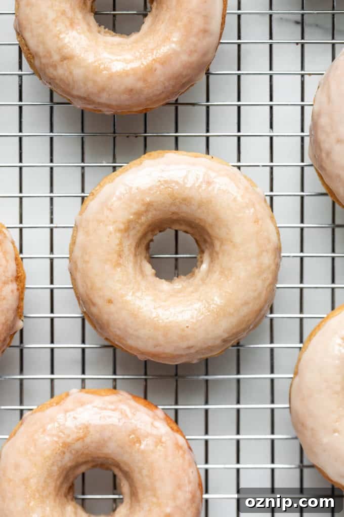Vegan Salted Maple Donuts with Maple Glaze 3 maple donuts on a metal cooling rack