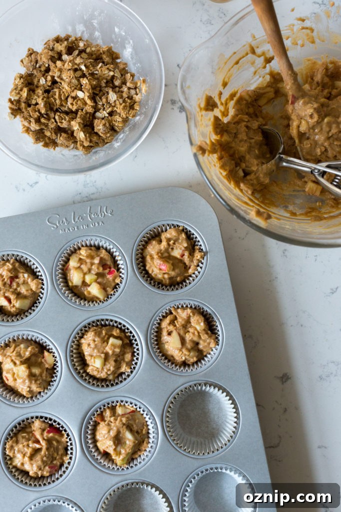 Filling muffin tin for Apple Cider Muffin batter