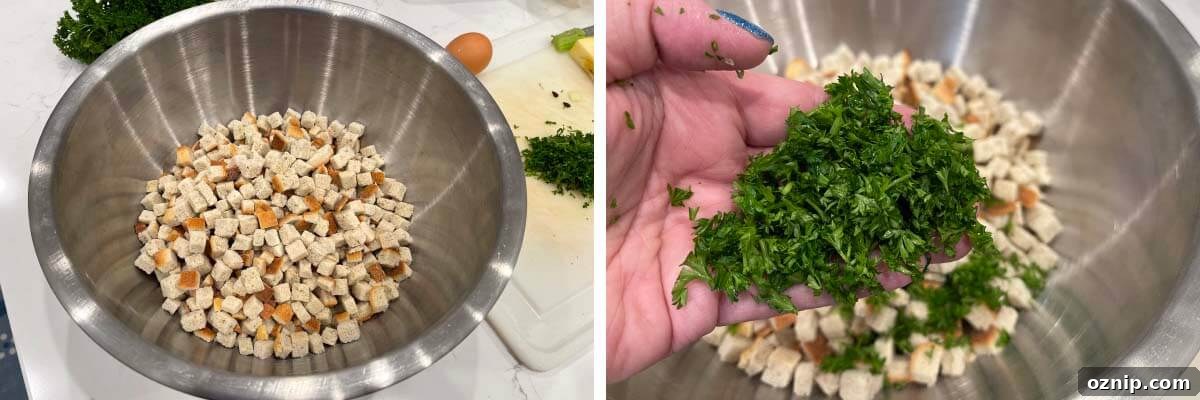 bread cubes in a stainless bowl, hand with chopped parsley